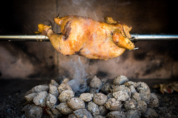 Cooking rotisserie chicken on the grill with Charcoal and Brique