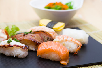 Sushi assortment on black dish, close up