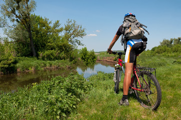 Mountain biker beside a beautiful river