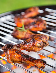 Delicious chicken legs on garden grill