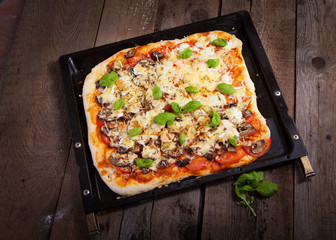 Homemade fresh pizza on wooden table