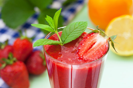Fresh strawberry juice with lemon and mint leaves