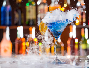 Cocktail with ice vapor on bar desk