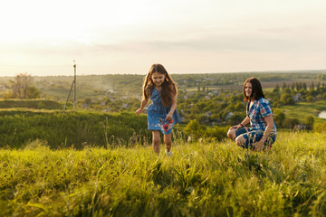 Little girl running on meadow