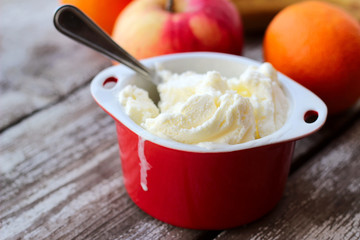 white ice cream in red bowl, selective focus