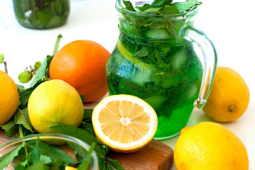 Green mojito cocktail with ice and mint