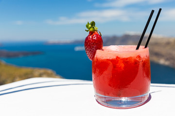Strawberry cocktail on background of the sea