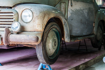 Detail of the front of an old car in garage