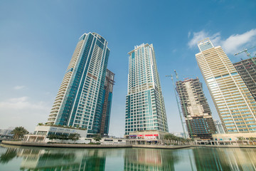 Fototapeta na wymiar Tall skyscrapers in Dubai near water