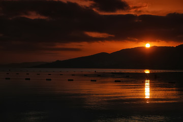 there is a horizon with filtered sea, sky and mountain