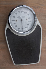 Bathroom scale isolated on brown  to check