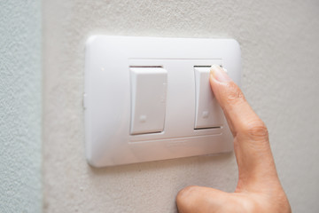 a woman press off light switch