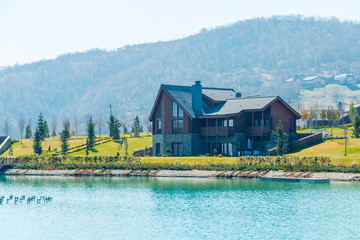 Modern house near water on bright day
