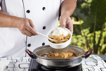 Chef shovel Japanese pork curry with steam rice