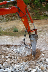 Large hydraulic Jackhammer Smashing Rocks