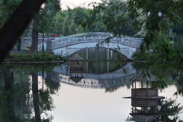 Openwork bridge over water at dusk