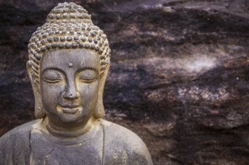 Close-up of Bouddha with stone on the background
