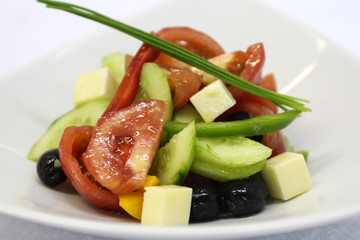 Delicious salad served in a white plate.