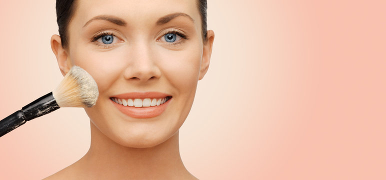 Happy Woman Applying Powder Foundation With Brush