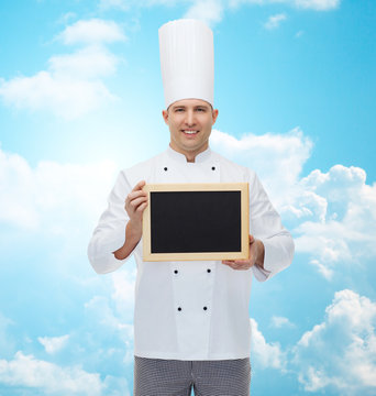 happy male chef cook holding blank menu board