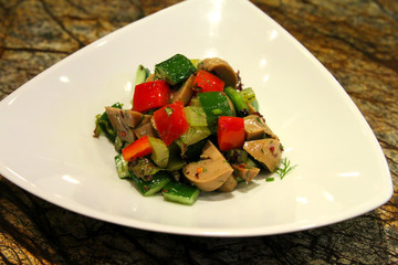 Delicious salad served in a white plate.