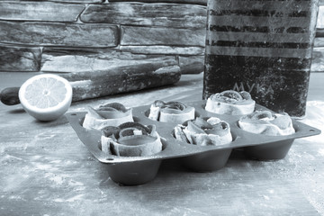 Silicone form with homemade pastries, a rolling pin, a jar of fl