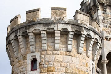 The round stone tower of the castle on the promenade in the town © strannik_fox