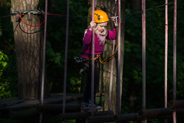 Obraz na płótnie Canvas Girl climbing in adventure park , rope park 