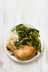 fried chicken with rice and vegetables on plate