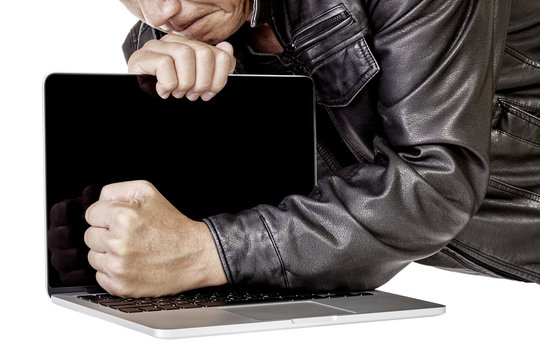 Computer thief stealing and breaking laptop