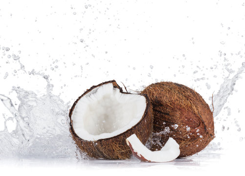 Cracked coconuts on white background