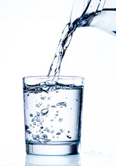 Filling glass with water from jug