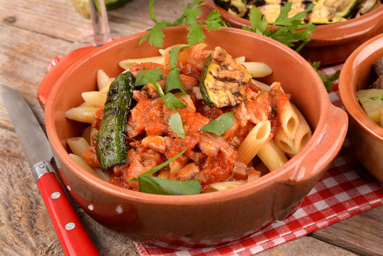 Penne with tomato sauce with bacon, zucchini and eggplants