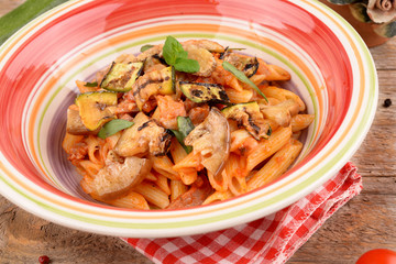 Penne with tomato sauce with bacon, zucchini and eggplants