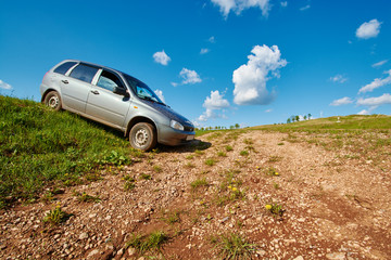 Fototapeta na wymiar Gray car standing in a field