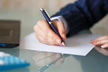 Businesswoman hand write on blank paper