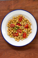 salad with chickpea and tomato on white plate