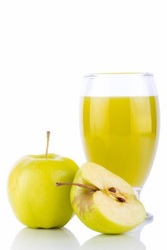 Apple juice in glass and green apples