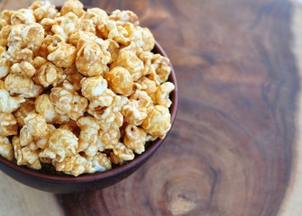 Golden Caramel Popcorn in a Bowl on a wooden table