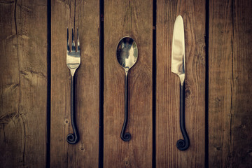 Cutlery - Vintage Fork, Spoon and Knife on Wood Background