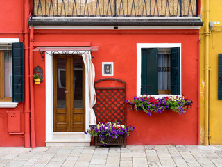 Burano, Italy - Red painted building. One of the ma