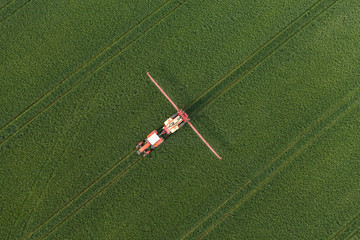 Naklejka premium aerial view of harvest fields with tractor