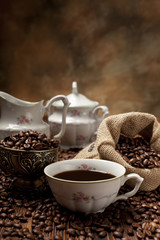 Obraz na płótnie Canvas Coffee cup, beans and canvas sack