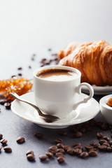 Fresh croissants  and cup of coffee on a table