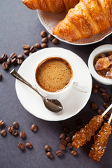 Fresh croissants and cup of coffee on a table