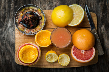 cut citrus fruit  juicer wooden background