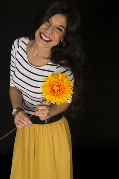 Happy Beautiful Female Model Holding A Big Yellow Flower Smiling