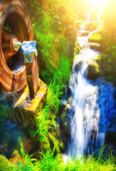 Small water mill with a stream in mountain forest. 
