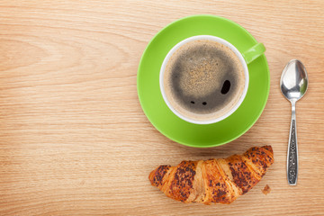 Cup of coffee and fresh croissant