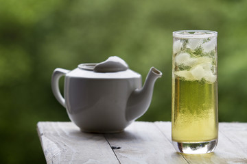 Green tea with ice in a tall glass